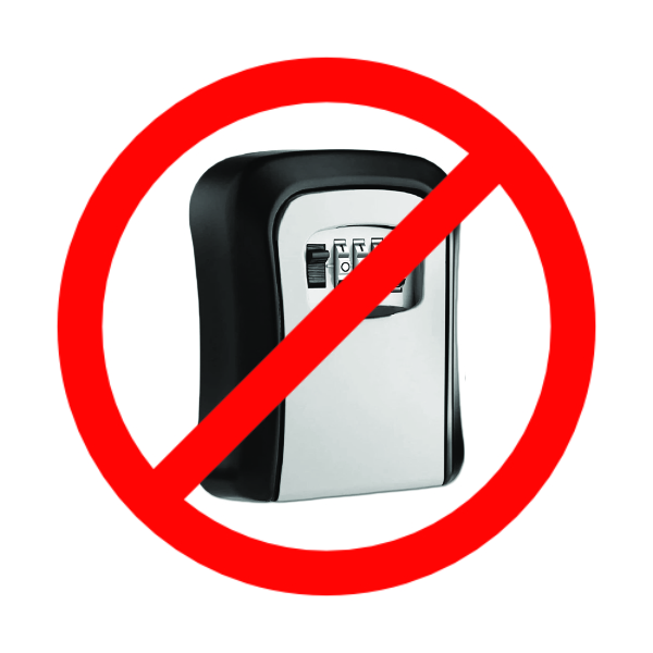A rotary combination lock style key safe, covered with a red circle-slash "not allowed" symbol
